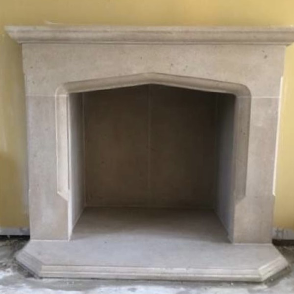Hand carved solid bath stone fireplace The Sunstone